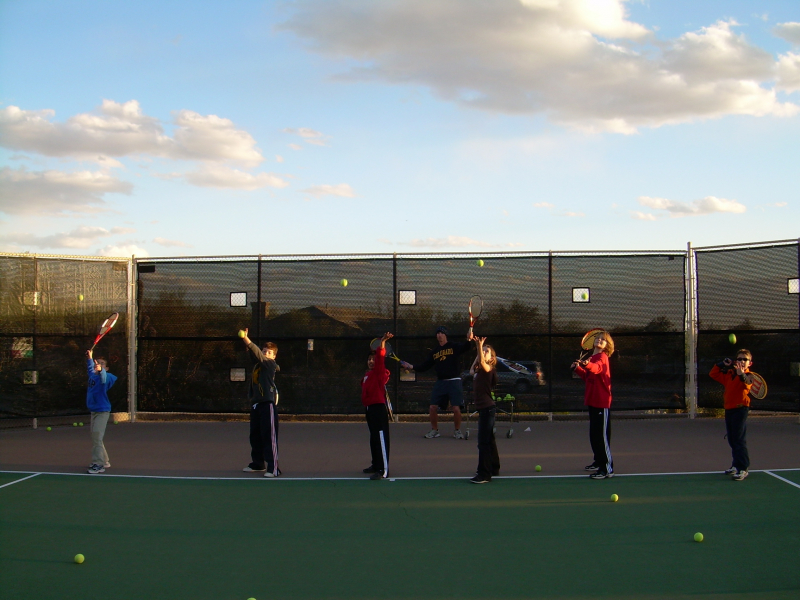 Members practicing tennis.